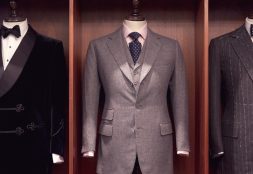 Three Henry Poole suits in their savile row shop
